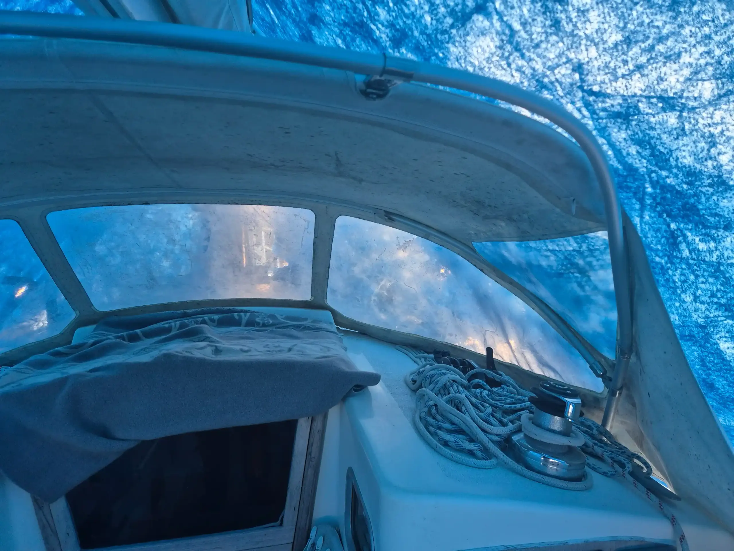 Worn sprayhood interior for Omega 36 prior to replacement with scratched and cloudy PVC window