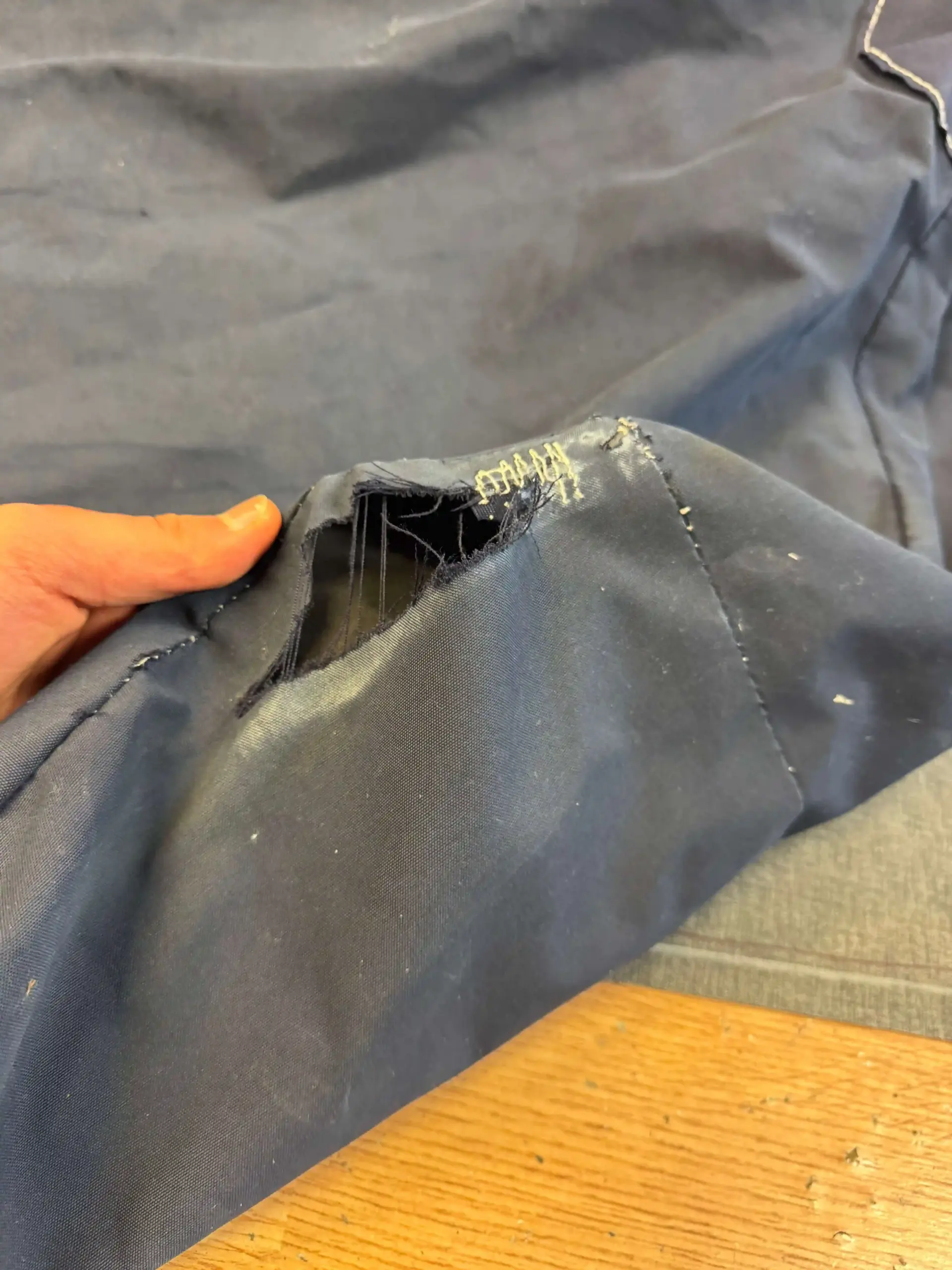 Damaged pulpet cover Nimbus Max 1 before new production - cracked boat canopy with UV wear and broken canopy fabric