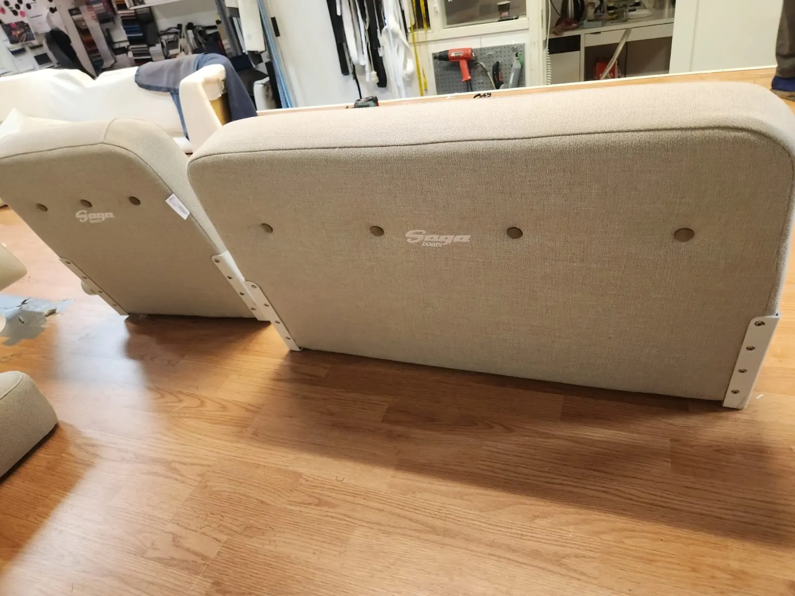 Saga 315 boat cushions with embroidered logo - beige seat cushion and sofa after professional reupholstery in Gothenburg